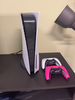 PS5 and 2 controllers