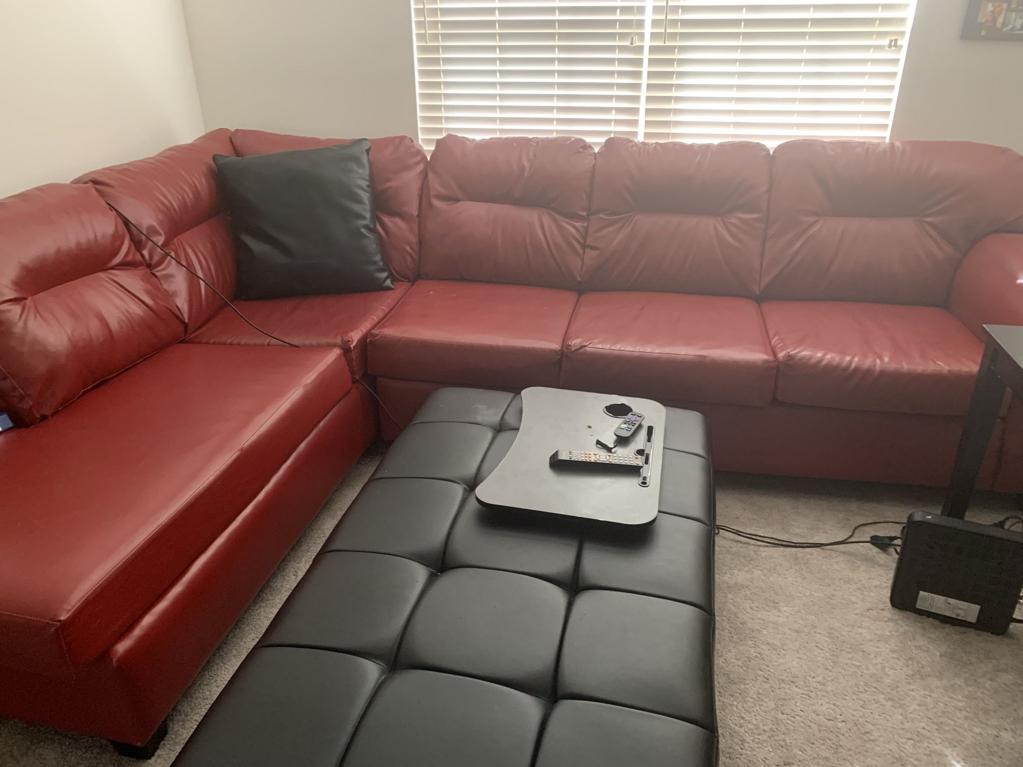 Red Leather Sectional and Black Leather Coffee Table