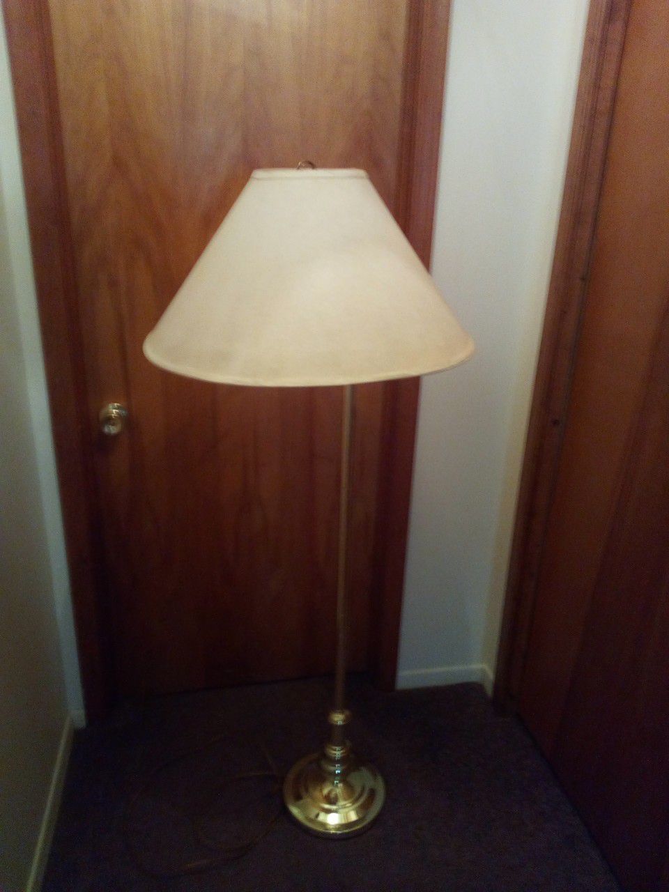 Polished brass floor lamp with swing arm /lamp shade is 23 inches in diameter /lamp height is 60 inches