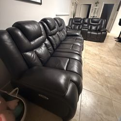 Comfortable black leather recliner sofa set with seating for 5 people.