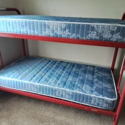 Good condition red bunk bed and mattresses