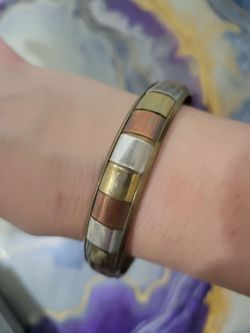 vintage tri-color mixed metal bangle bracelet featuring alternating rectangular panels of brass, copper, and silver-tone metal