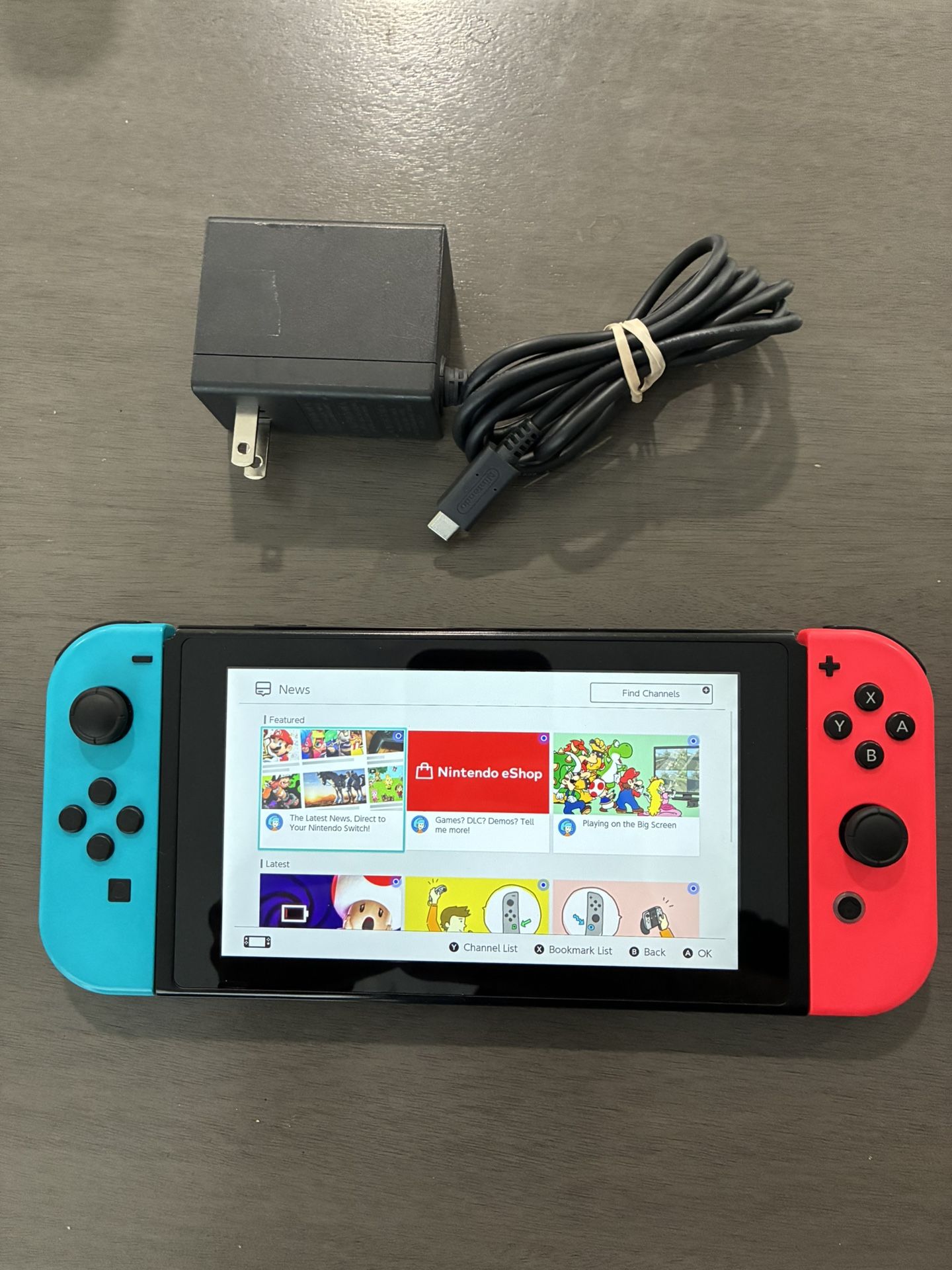 Nintendo Switch System / Console - Red Blue Version - Works Good - Includes Charger. System has some scratches but works good. Only comes with home ch