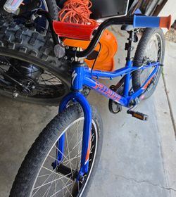 blue and orange Specialized Riprock 20" kids mountain bike.