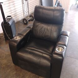 Black Leather Power Recliner With Power Headrest And Charging Ports.