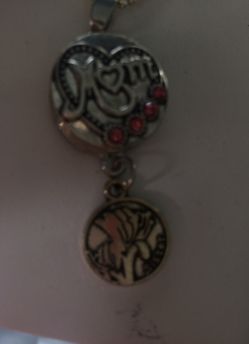 Charm pendant with a lily flower charm