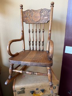 Antique oak child’s rocking chair with bentwood arms