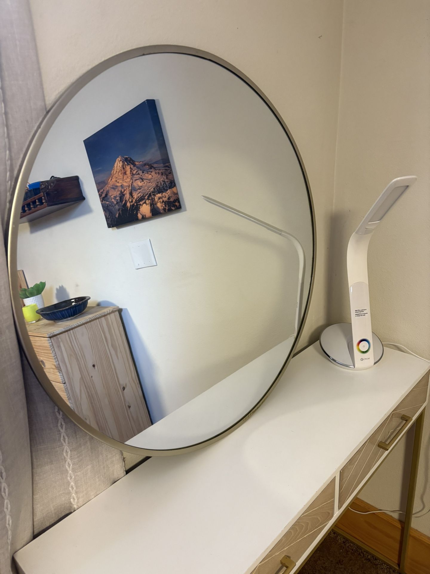 gold metal-framed round wall mirror