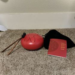 Steel Tongue Drum With Small Sheet Music Book