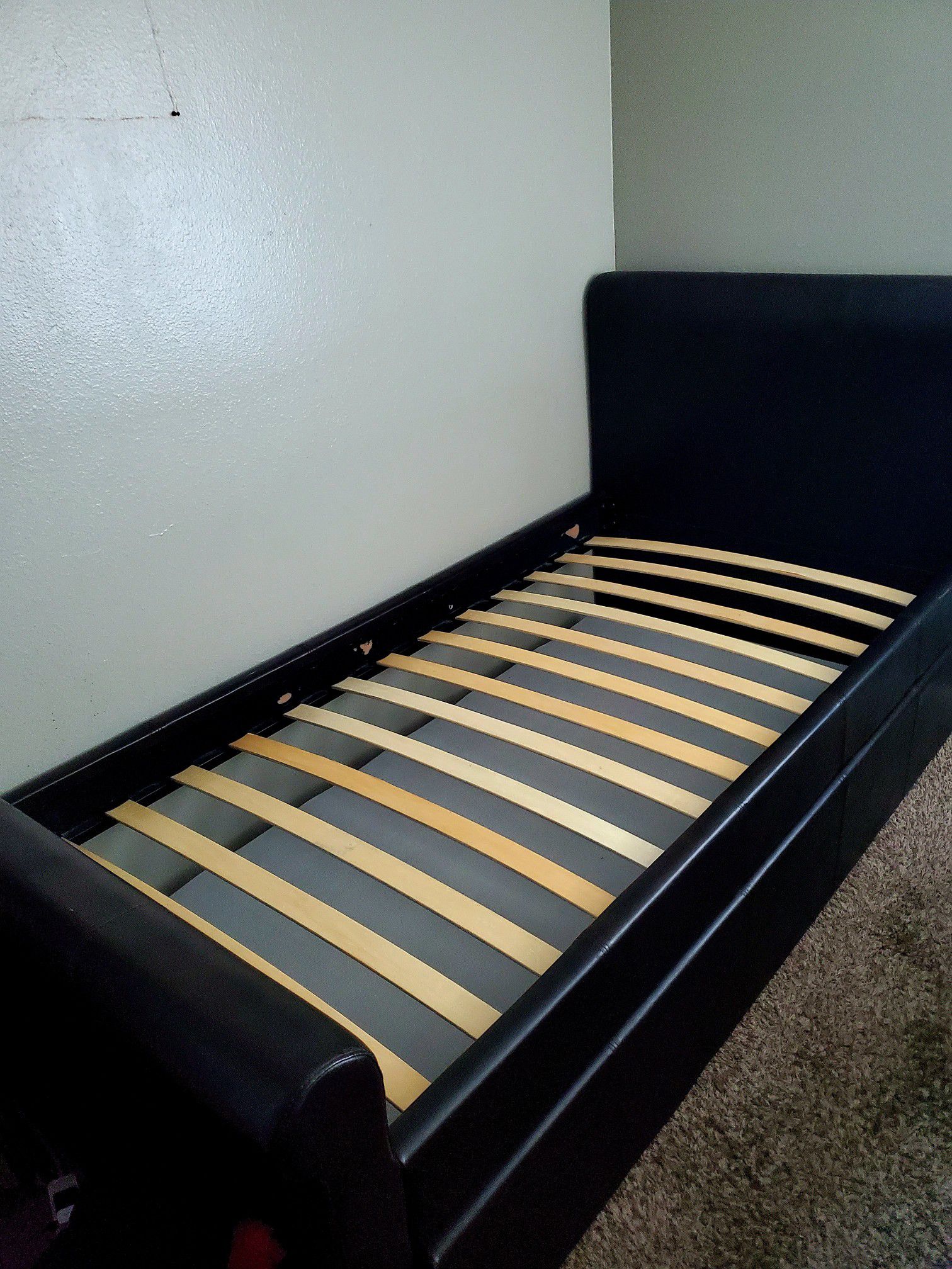 Twin bed-frame with pullout.