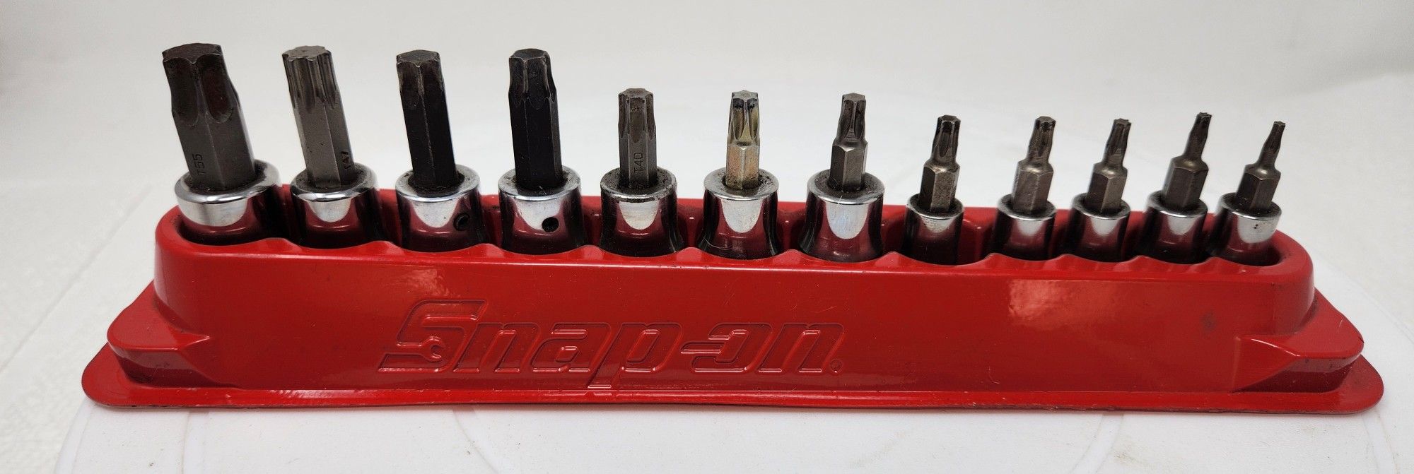 The Snap On 212EFTXY T8-T55 12 Piece 1/4"/3/8" Drive TORX Bit Standard Socket Set is a high-quality hand tool set