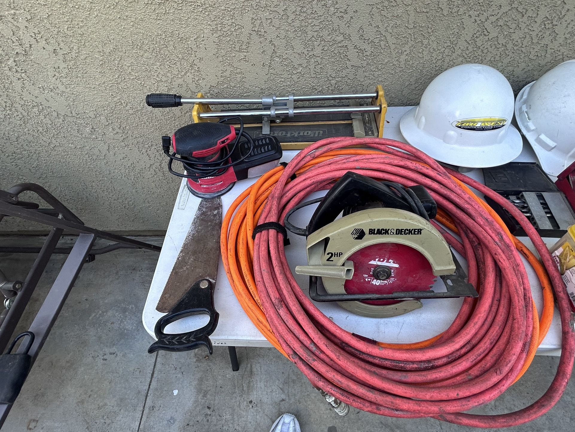 Air Hoses And Electric Hand Saw