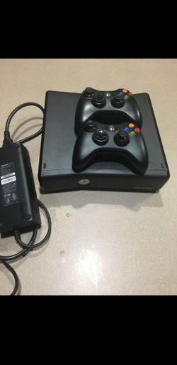 Like New Xbox 360 Black with 3 controllers and 20 games.