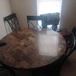 Round dining room table and four chairs
