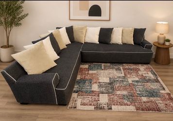 Sectional fabric sofa with contrasting white pipe details and neutral decorative cushions can be delivered for an additional cost Presio 250
