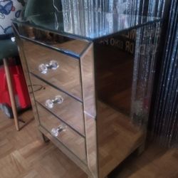 Mirrored nightstand for the bedroom has two small cracks.