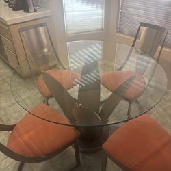 Glass Table And Red Chairs