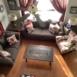 Brown Couch And Loveseat, Flowered Chair, All of the Extra Pillows