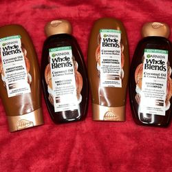 Garnier Whole Blends Coconut Oil & Cocoa Butter Smoothing Shampoo and Conditioner in 12.5 fl oz (370 ml) bottles.  Key features include: Purpose: The 