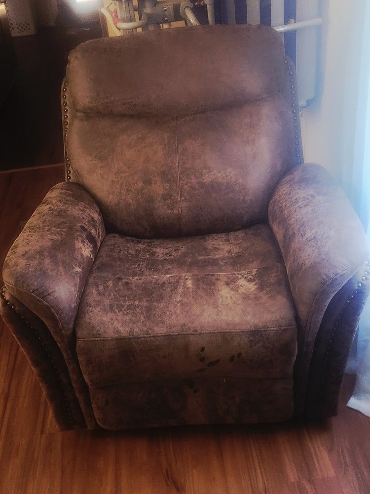 Its dark And Light Brown Color Together. Its Medium In Size And Rolls Out Into a Pretty Good Sze Recliner bed and Is pretty Comorfortable.