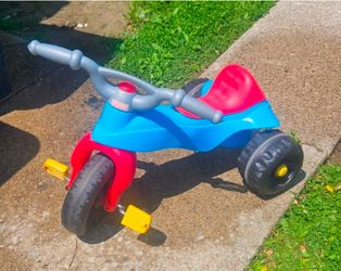 Fisher-Price three wheeler, Heavy duty plastic wheels, a storage under seat is included all in Excellent condition.