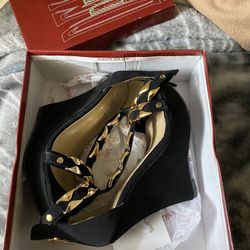 Women’s black and gold wedges