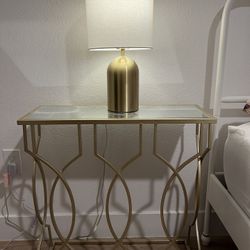 Gold colored table with lamp
