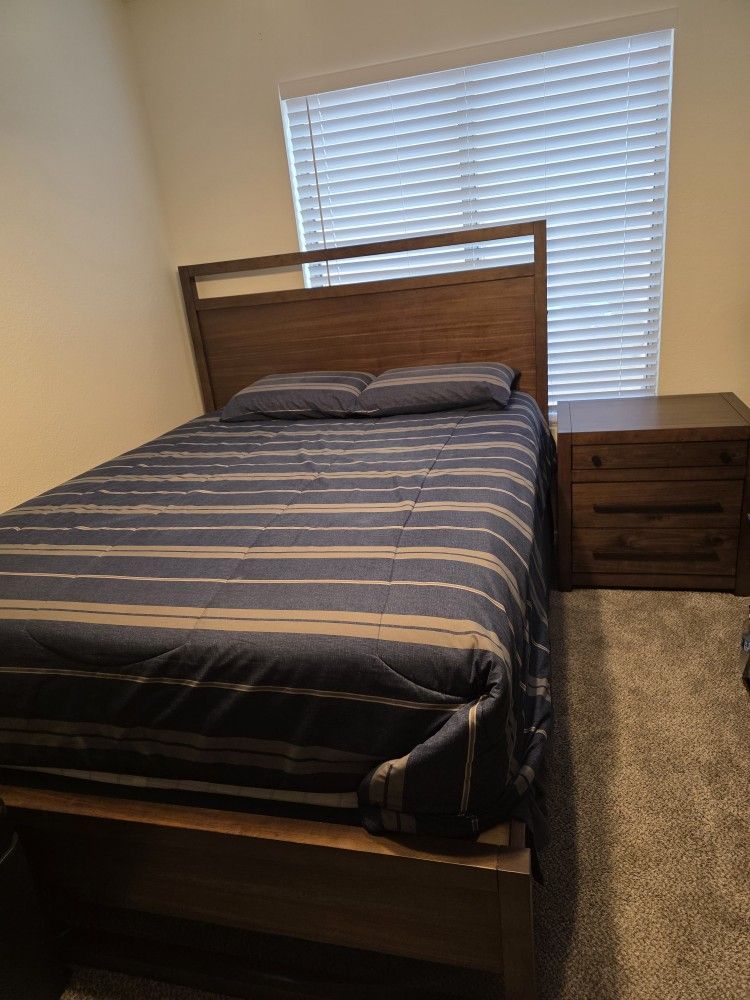 Queen size bed with two  side tables and  armoire.
