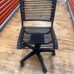 Black Desk Chair With Elastic Back And Bottom.