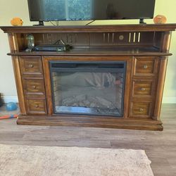 Wooden entertainment center with electric fireplace