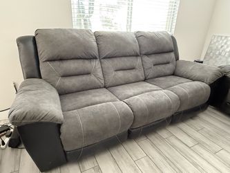 Couch.  Grey with recliners on each side.