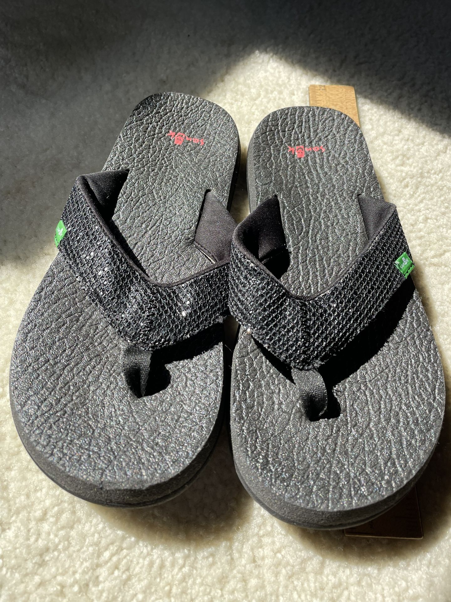 black sanuk flip flops