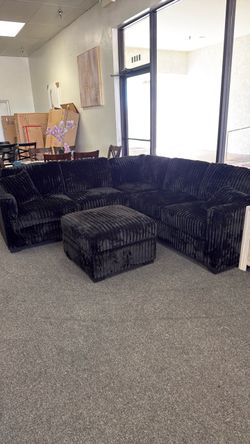 Black corduroy sectional with ottoman
