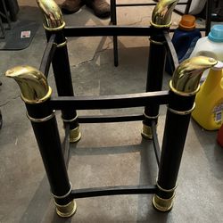Black metal finish coffee table with gold accents and glass top￼