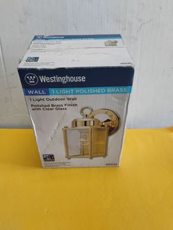 Westinghouse 1-light outdoor wall lantern featuring a polished brass finish and clear glass panels