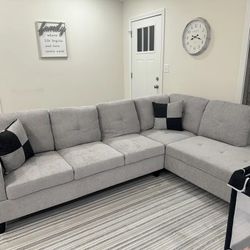 Light Gray Sectional Couch and Ottoman