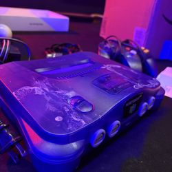 Purple Nintendo 64 with wires and controller