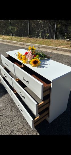 Modern wooden white long dresser with big drawers. Drawers sliding smoothly