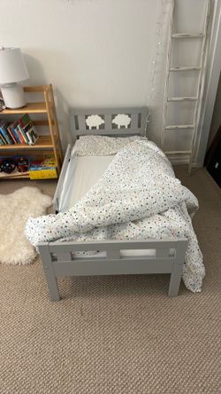 Pair of pristine toddler beds in wood frames, including two matching mattresses.
