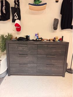 Moving out of LA and need this gone — 6-drawer dresser in gray wood-grain finish, under 2 years old, from a smoke-free home. Drawers all slide smoothl