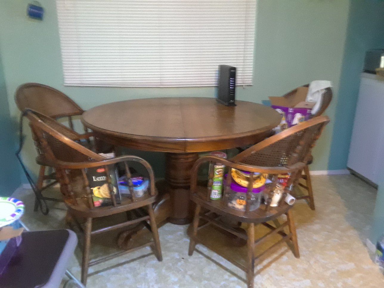 Solid oak dining table with leaf and 4 barrel chairs.