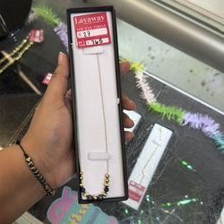 Thin necklace with blue and gold beads