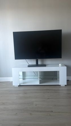 55” Flat screen TV/ White TV stand with LED lights.