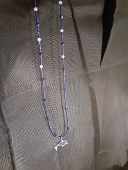 Necklace with dolphin pendant
