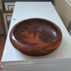 Handcrafted wooden serving bowl adorned with intricately etched floral designs $30.00