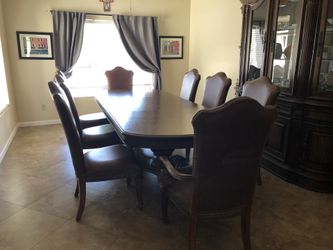 Thomasville Dark wooden table seats 4-8.