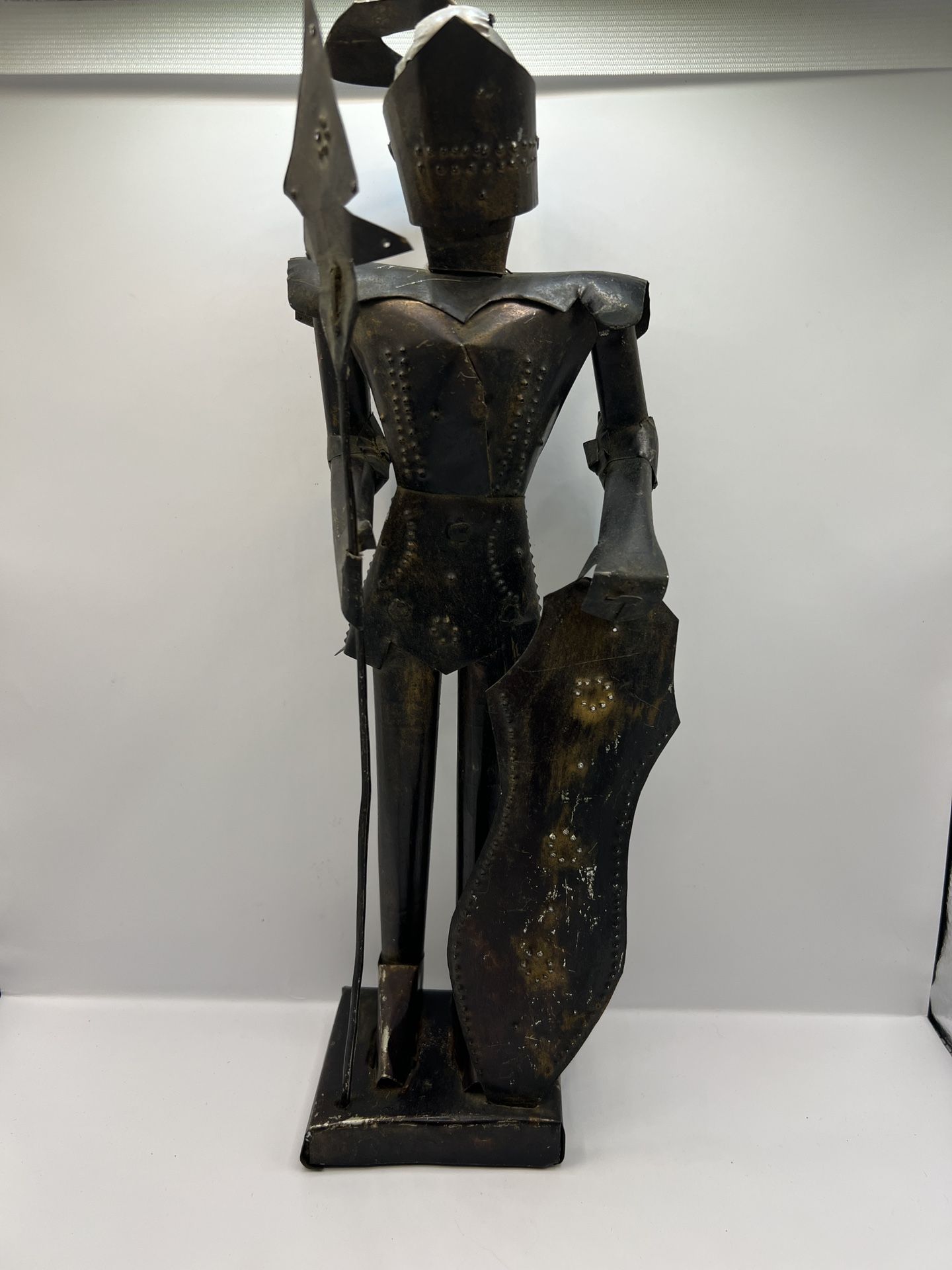 Mexican folk art punched tin knight in armor sculpture.• The