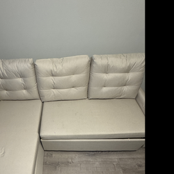 Tan Sectional Pull out Couch in Good Condition.
