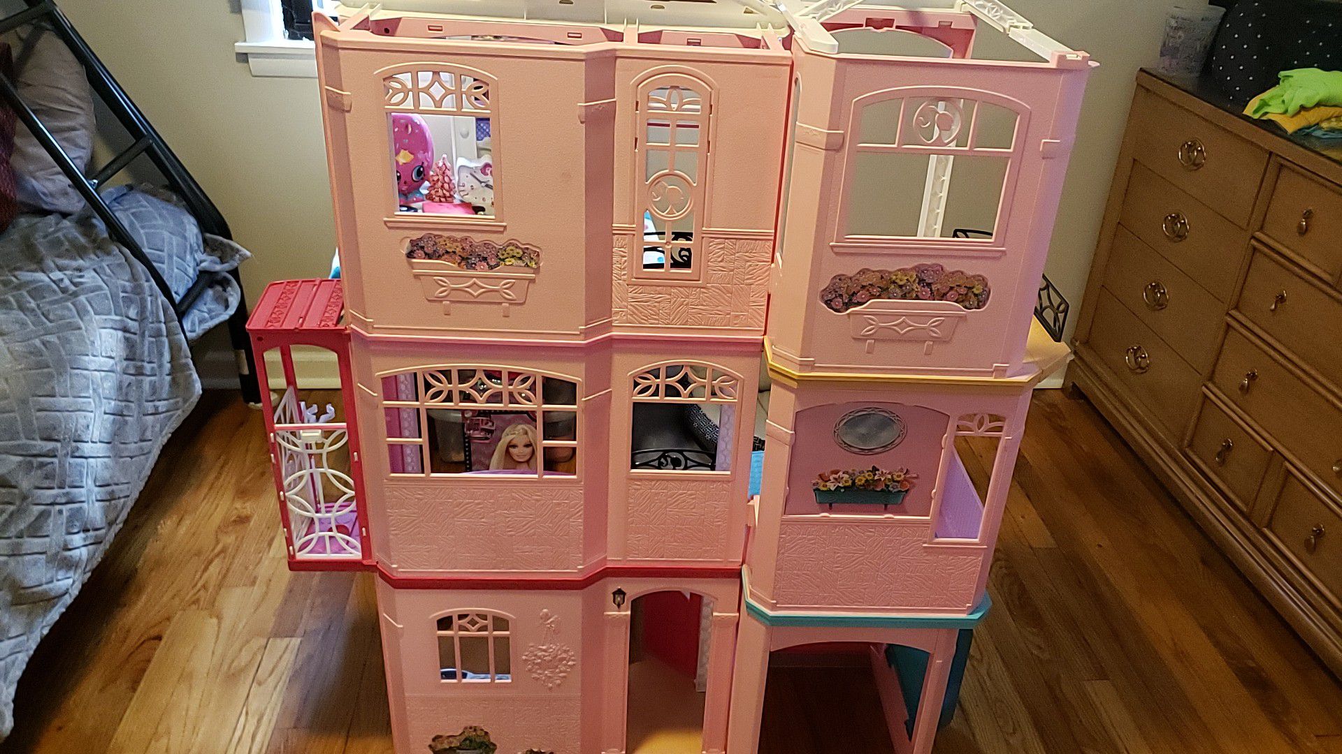 Barbie house with lots of barbies and clothes asking $175.. over $250 worth of things.