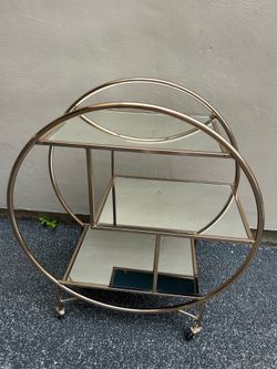 Gold tone bar cart with mirror shelves